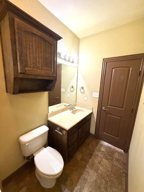 2410 South 2nd Street, Unit 1162 Waco, TX 76706 - Photo 26 of 33 a bathroom with a granite countertop toilet sink and mirror