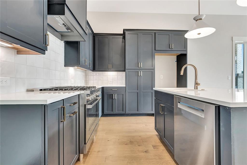 170 Rolison Way Fayetteville, GA 30214 - Photo 11 of 49 a kitchen with stainless steel appliances granite countertop a sink stove and refrigerator