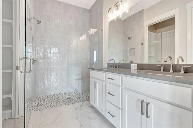 a bathroom with a shower sink and mirror