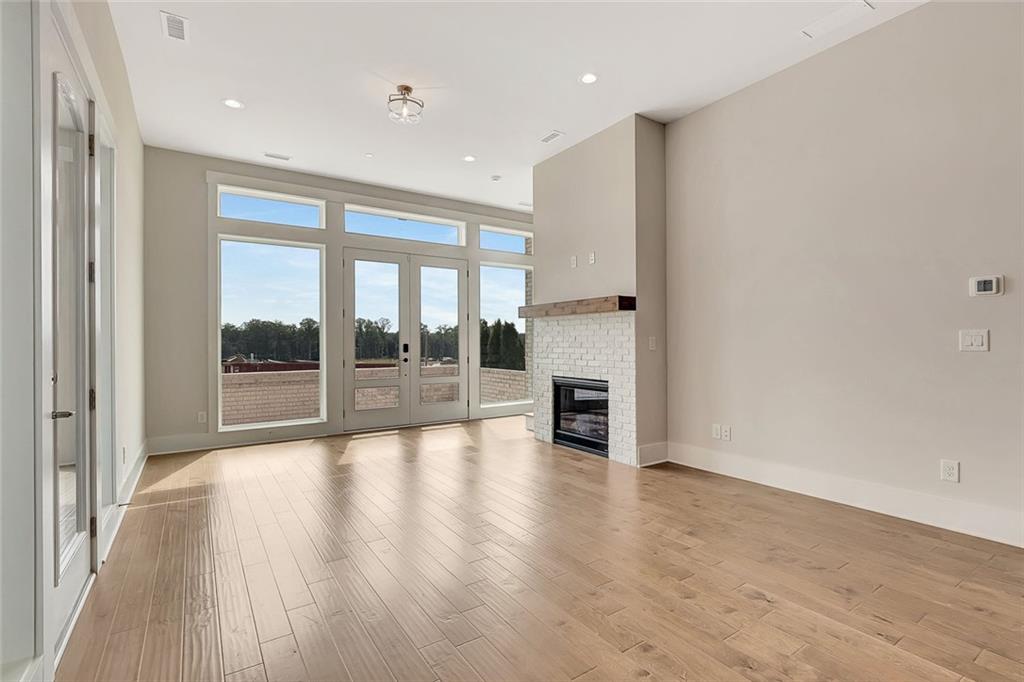 170 Rolison Way Fayetteville, GA 30214 - Photo 7 of 49 a view of an empty room with wooden floor and a window
