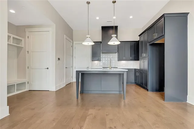 a kitchen with kitchen island a sink stainless steel appliances and cabinets