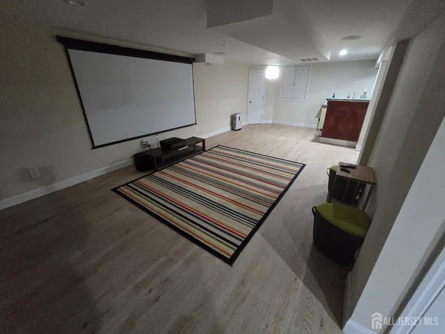 a room with wooden floor and windows