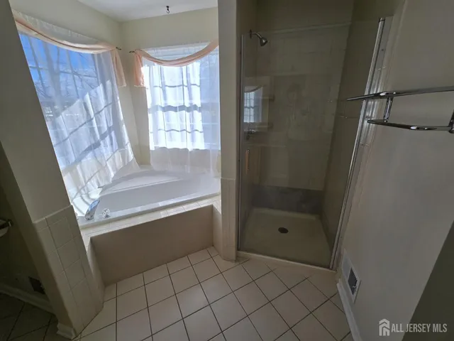 a bathroom with a bathtub and a shower