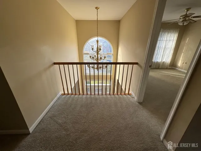 a view of a hallway with a chandelier