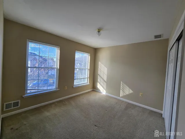 a view of an empty room with windows