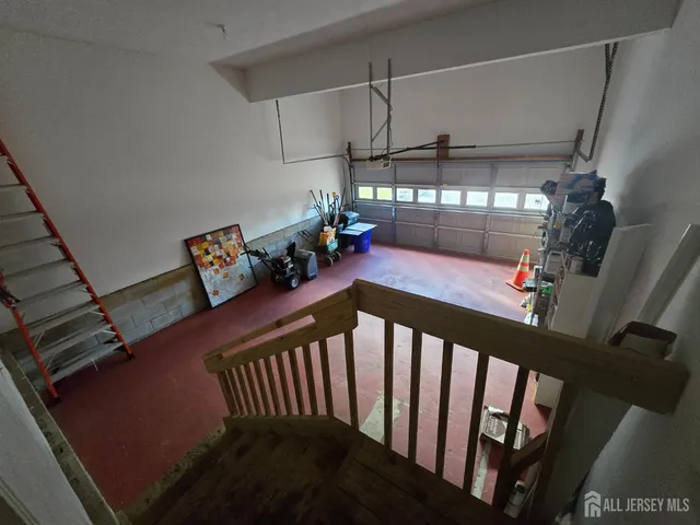 a view of a porch with furniture and lots of frames on wall