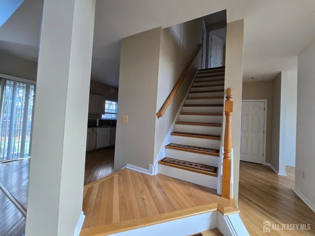 a view of entryway and hall with wooden floor