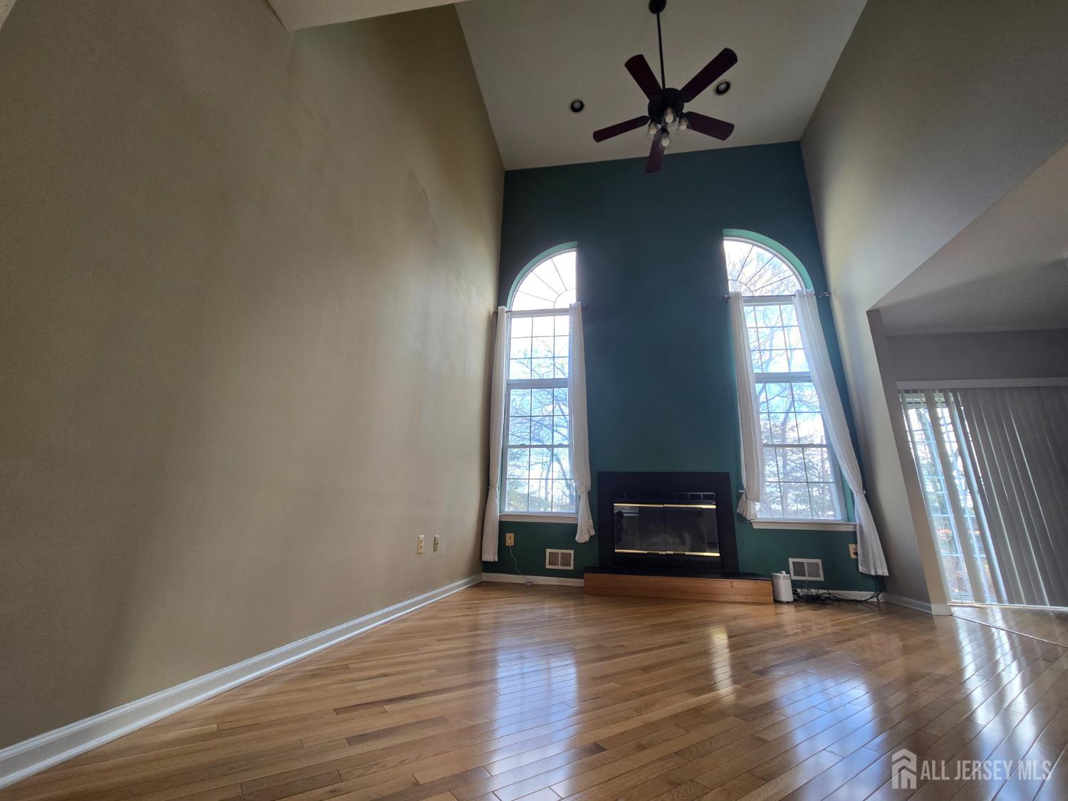 40 Potomac Road Monmouth Junction, NJ 08852 - Photo 7 of 48 an empty room with wooden floor and windows