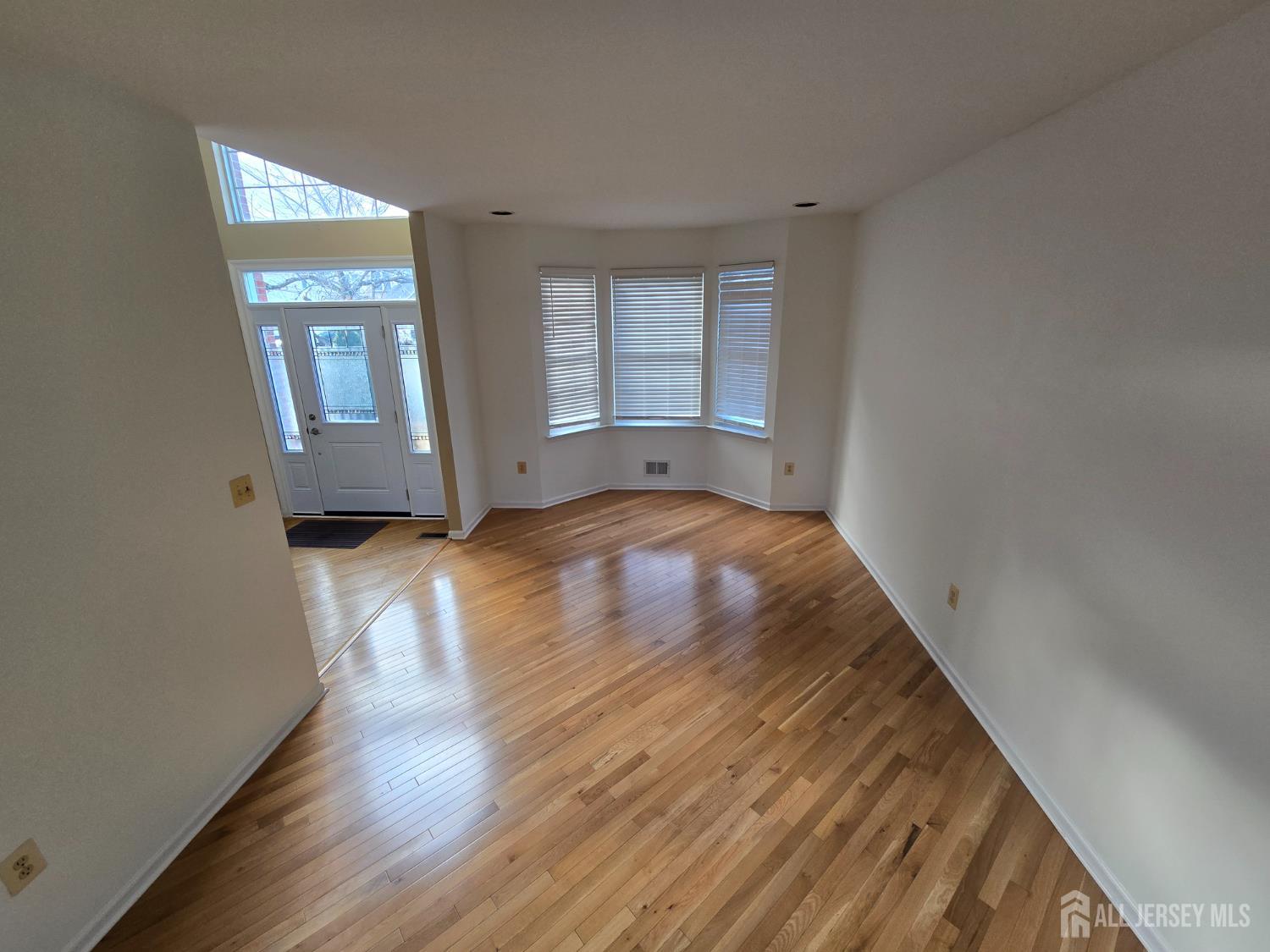 40 Potomac Road Monmouth Junction, NJ 08852 - Photo 10 of 48 a view of an empty room with wooden floor and a window