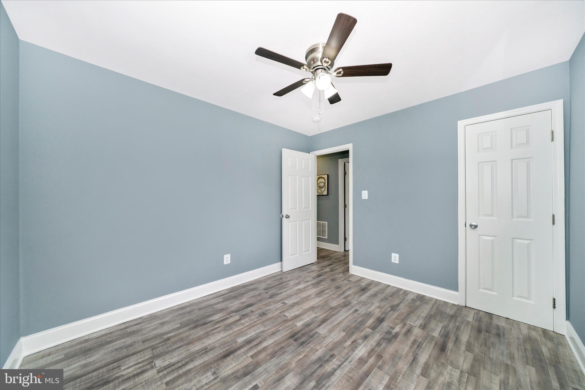 6737 Allentown Road Temple Hills, MD 20748 - Photo 42 of 51 a view of a livingroom with a ceiling fan and wooden floor