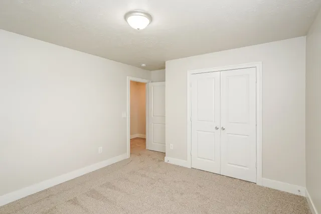 an empty room with closet area