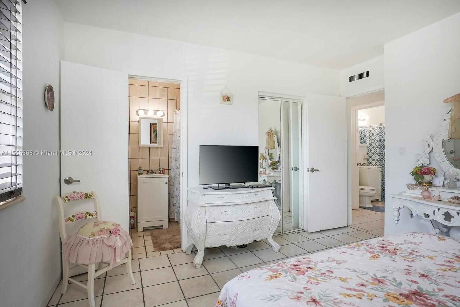 8461 Southwest 38th Street Miami, FL 33155 - Photo 11 of 27 a bedroom with a bed and flat screen tv