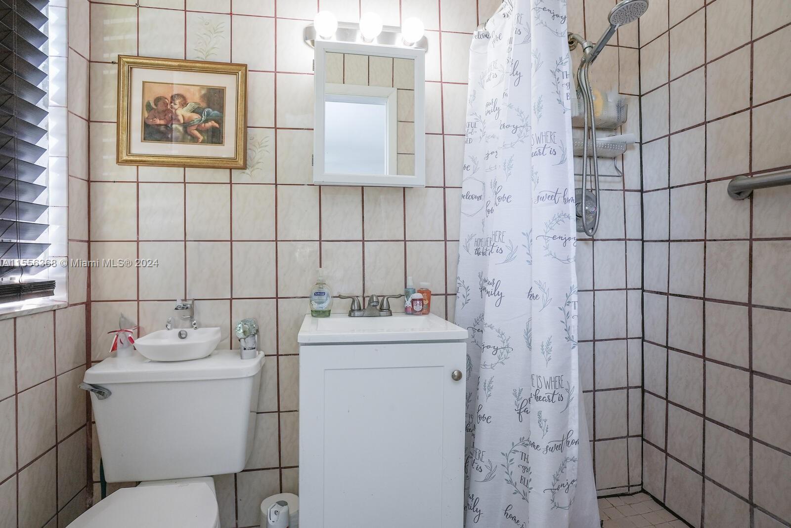 8461 Southwest 38th Street Miami, FL 33155 - Photo 12 of 27 a bathroom with a toilet and a shower