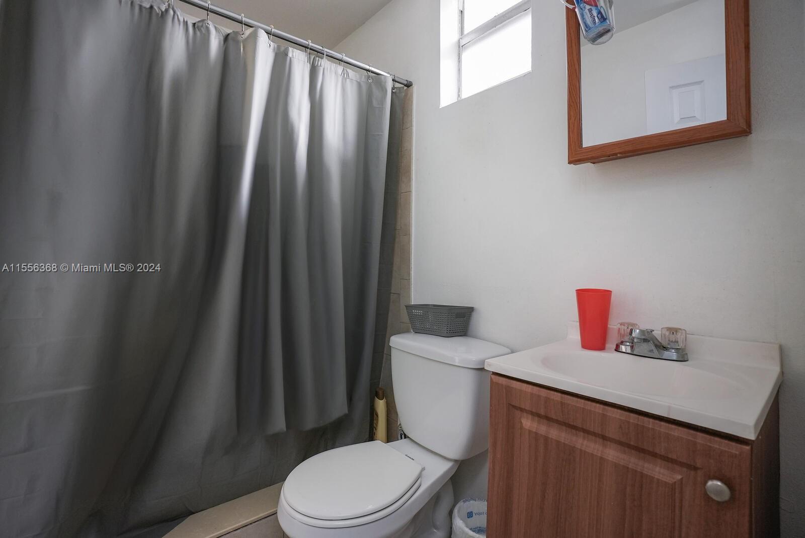 8461 Southwest 38th Street Miami, FL 33155 - Photo 20 of 27 a white toilet sitting next to a bathroom sink