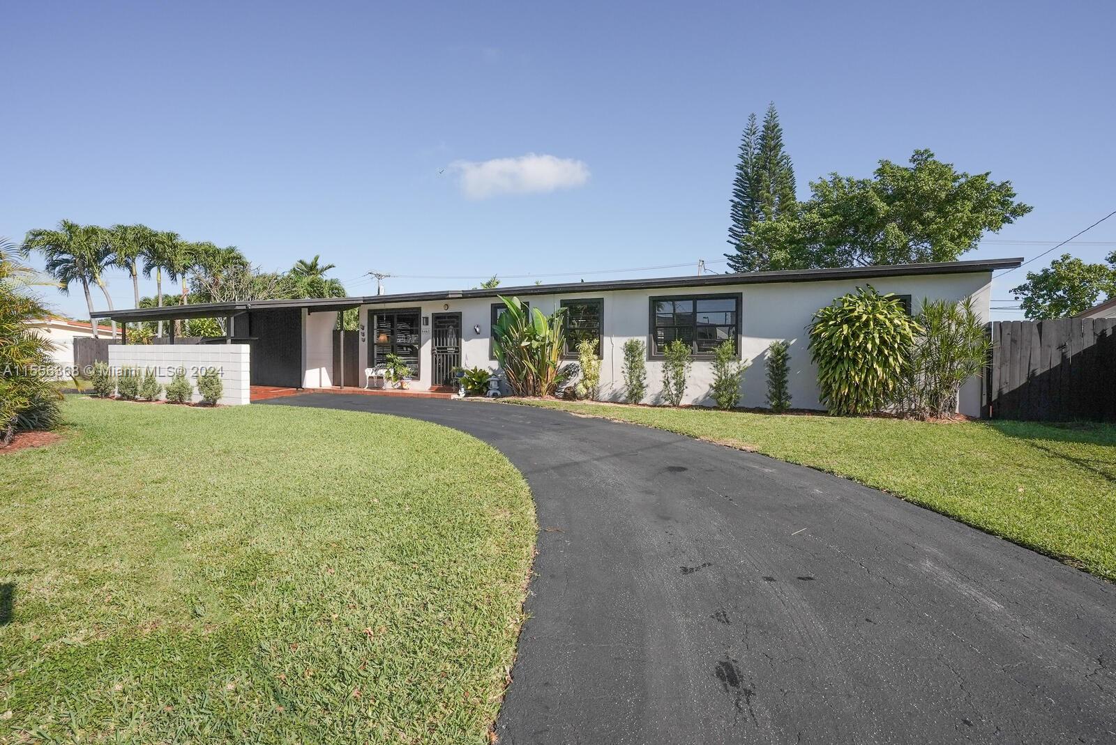 8461 Southwest 38th Street Miami, FL 33155 - Photo 2 of 27 a front view of a house with garden
