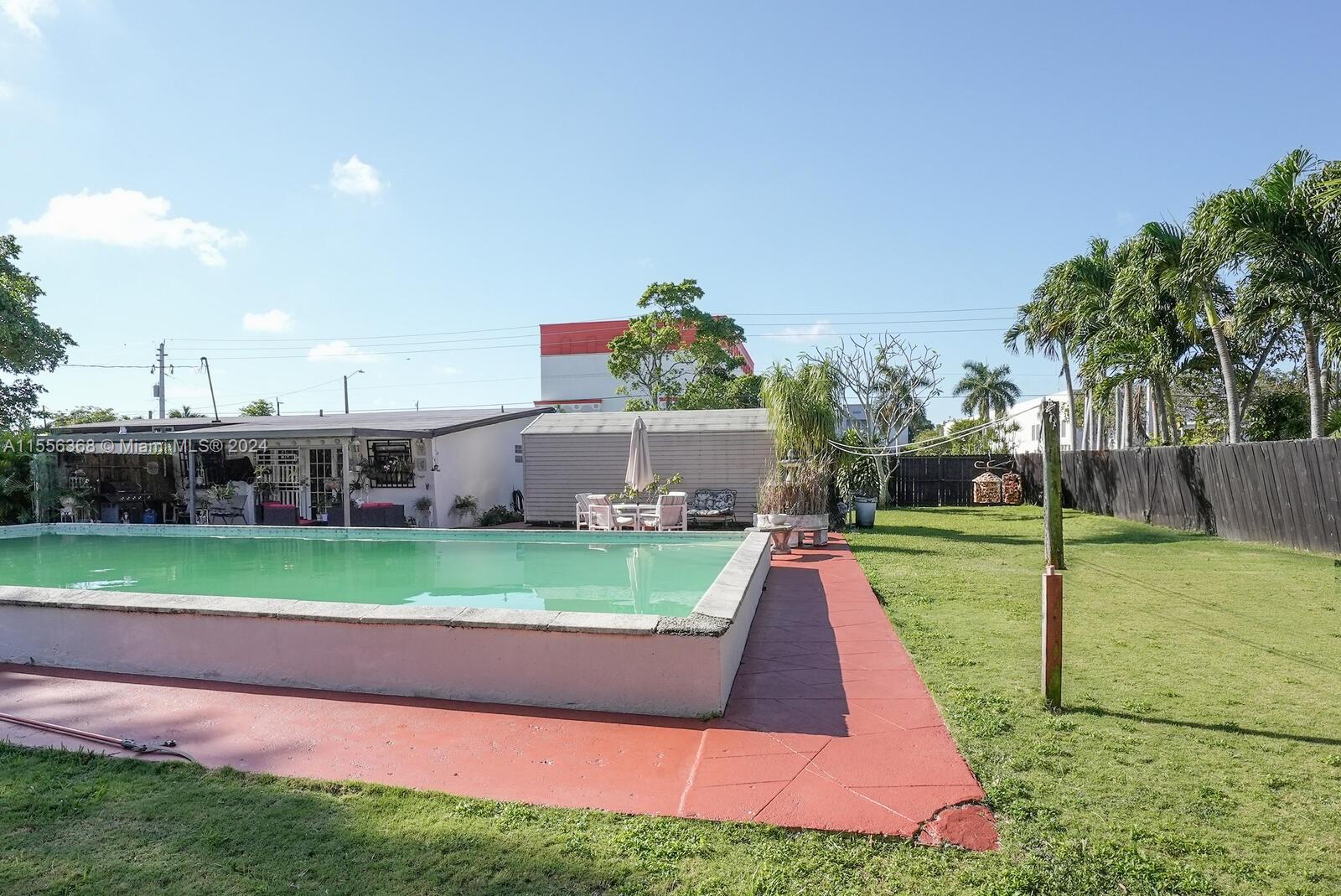 8461 Southwest 38th Street Miami, FL 33155 - Photo 21 of 27 a view of backyard with swimming pool and green space