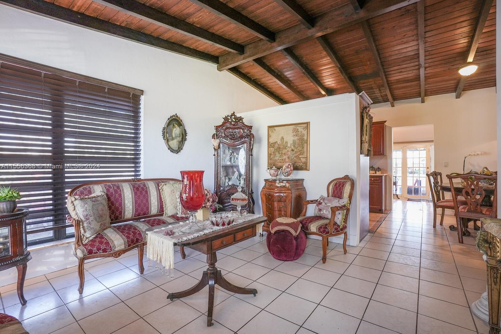 8461 Southwest 38th Street Miami, FL 33155 - Photo 3 of 27 a living room with furniture a table and chairs