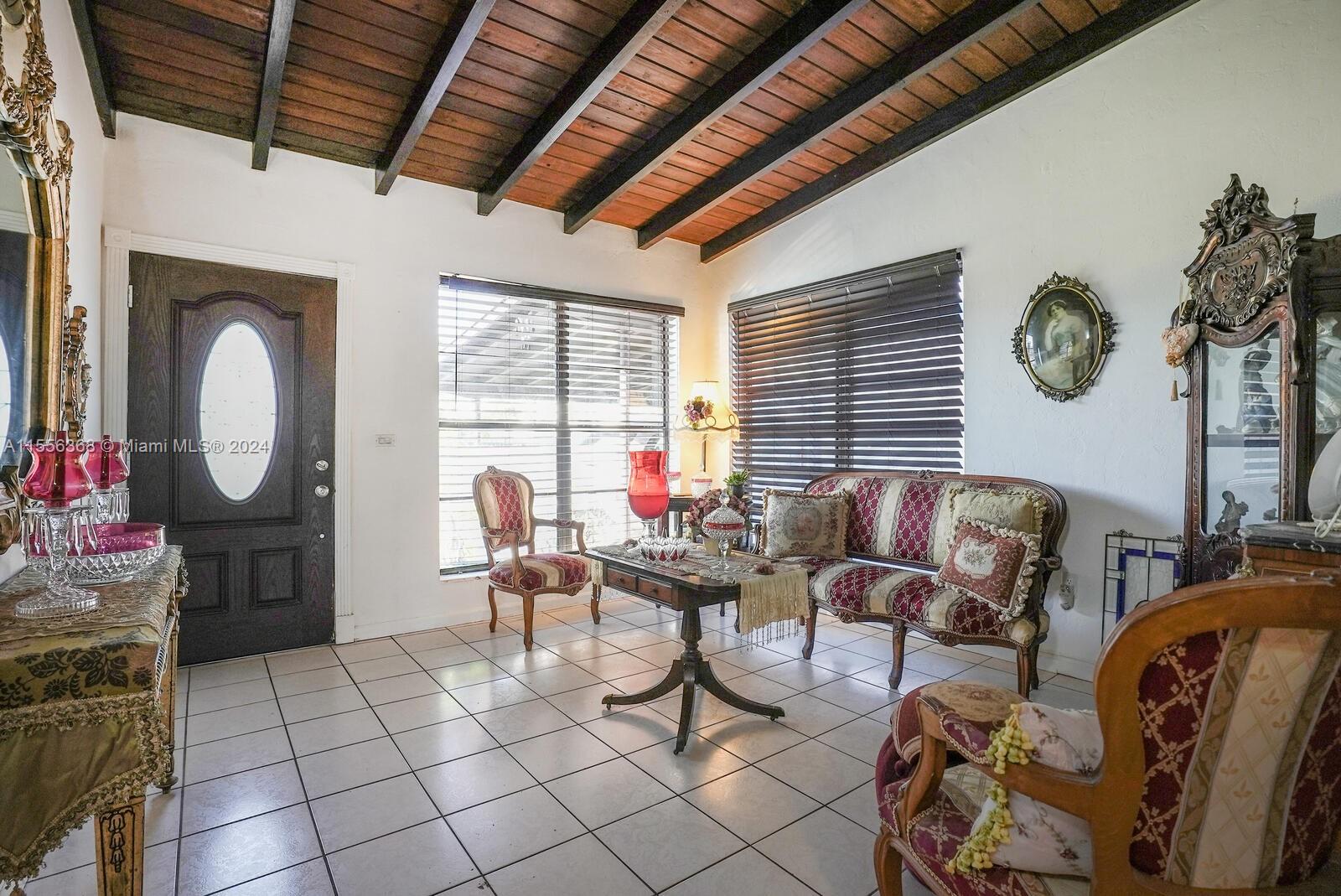 8461 Southwest 38th Street Miami, FL 33155 - Photo 4 of 27 a living room with furniture a window and a clock