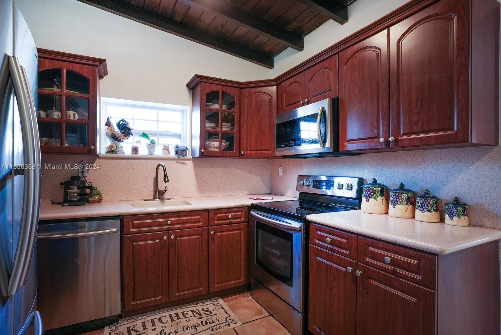 8461 Southwest 38th Street Miami, FL 33155 - Photo 6 of 27 a kitchen with stainless steel appliances granite countertop a sink stove and cabinets