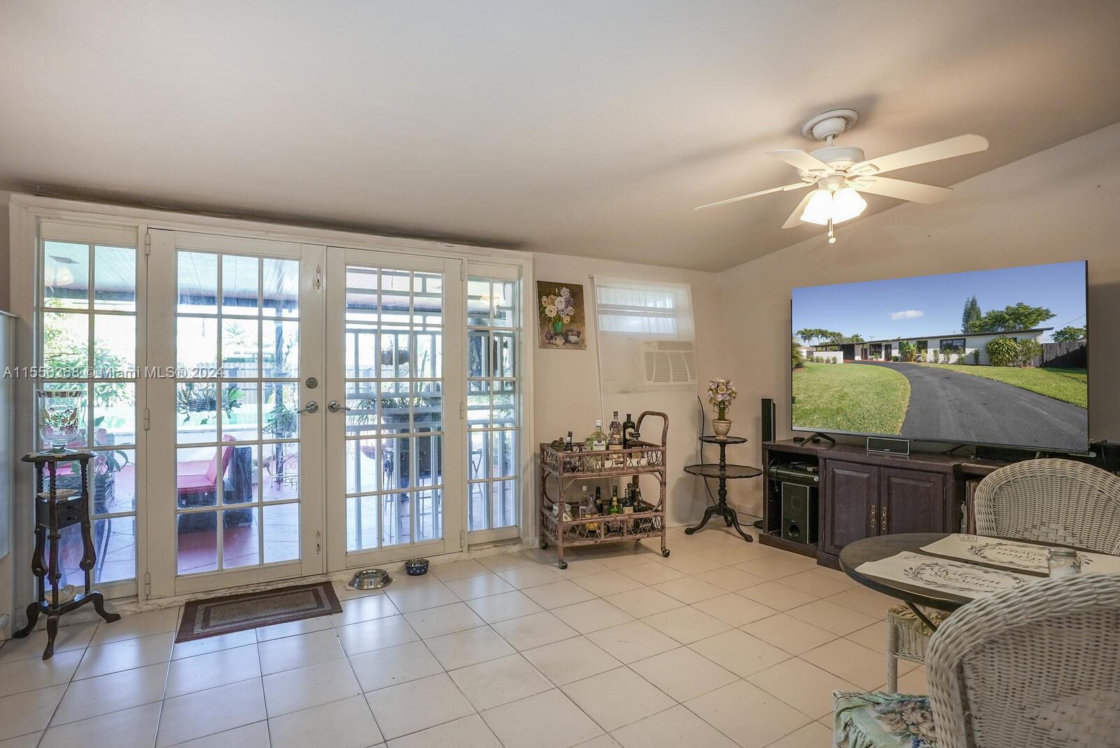 8461 Southwest 38th Street Miami, FL 33155 - Photo 8 of 27 a bedroom with furniture and large windows