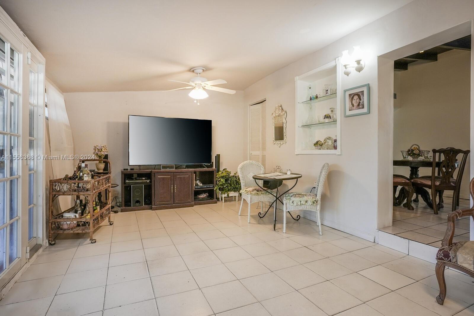 8461 Southwest 38th Street Miami, FL 33155 - Photo 9 of 27 a living room with furniture and a flat screen tv