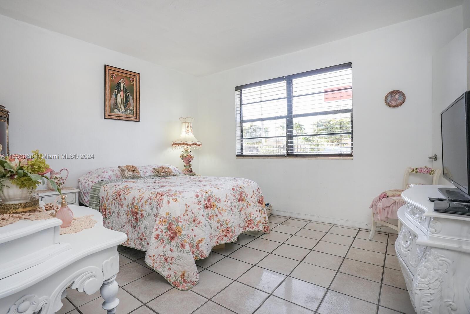 8461 Southwest 38th Street Miami, FL 33155 - Photo 10 of 27 a bed room with a bed and a window