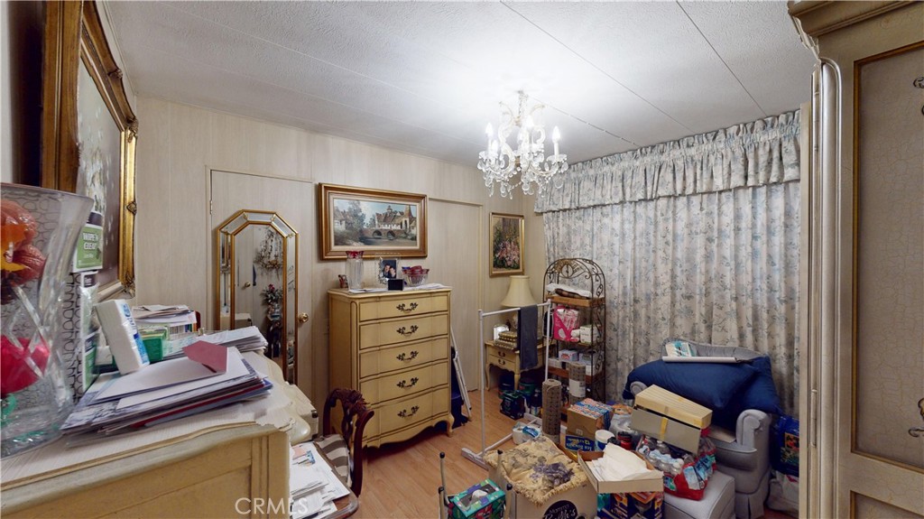 14851 Jeffrey Road, Unit 117 Irvine, CA 92618 - Photo 25 of 45 a bedroom with a bed and a chandelier