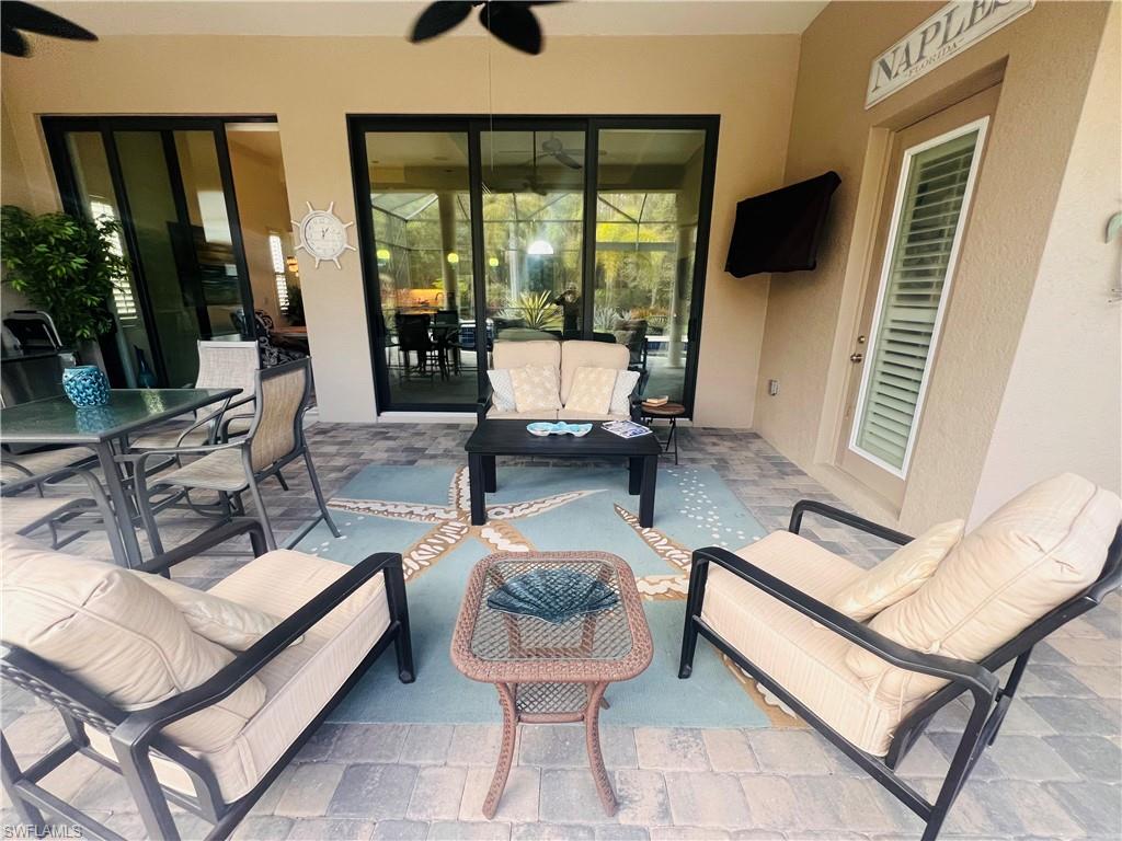 6574 Amarone Lane Naples, FL 34113 - Photo 38 of 44 a living room with furniture and a large window