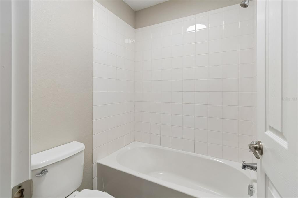 1192 Multiflora Loop Lutz, FL 33558 - Photo 24 of 32 a white bath tub sitting next to a white toilet