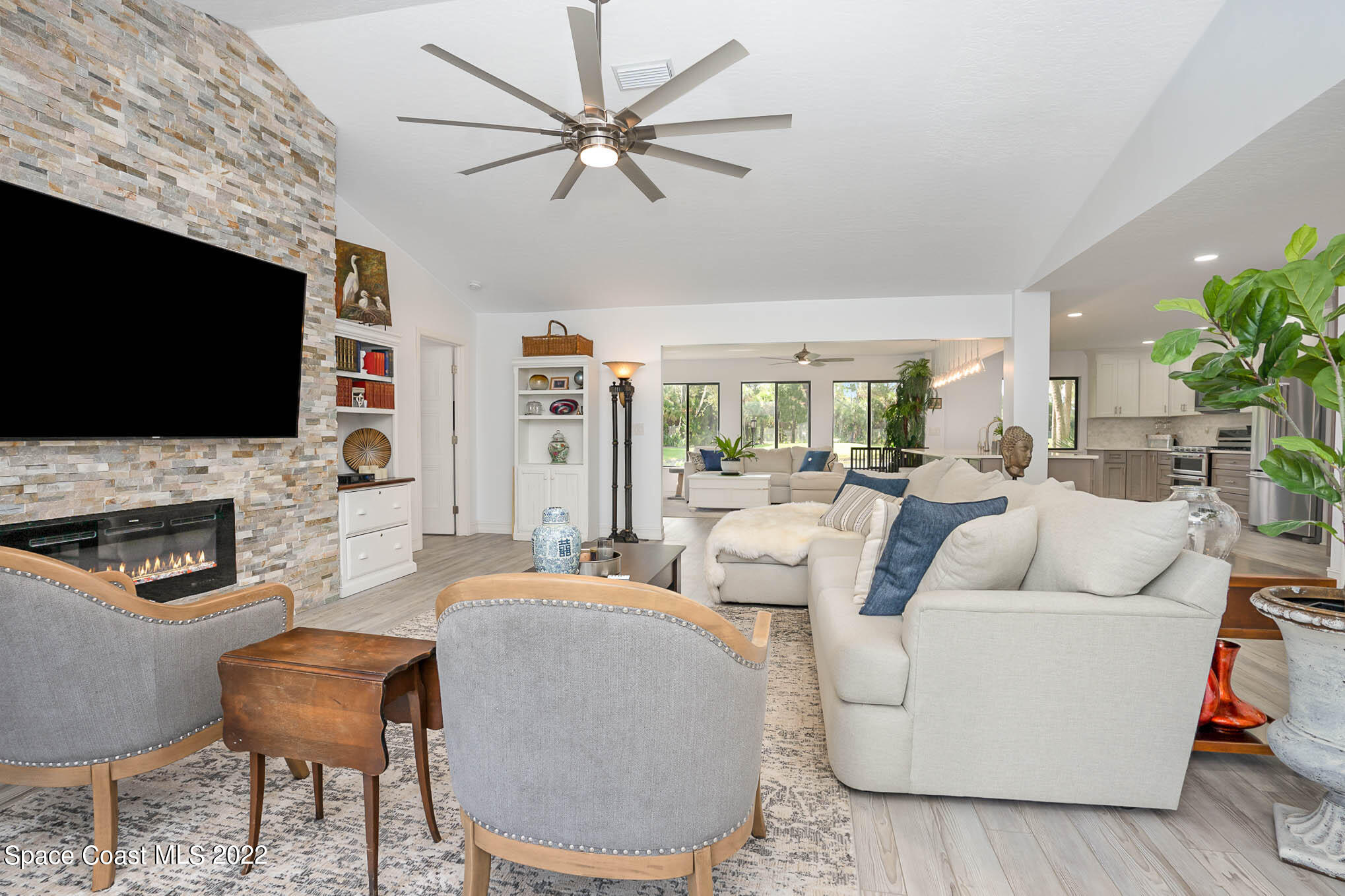 1425 Kitty Hawk Way Melbourne, FL 32940 - Photo 11 of 53 a living room with fireplace furniture and a flat screen tv