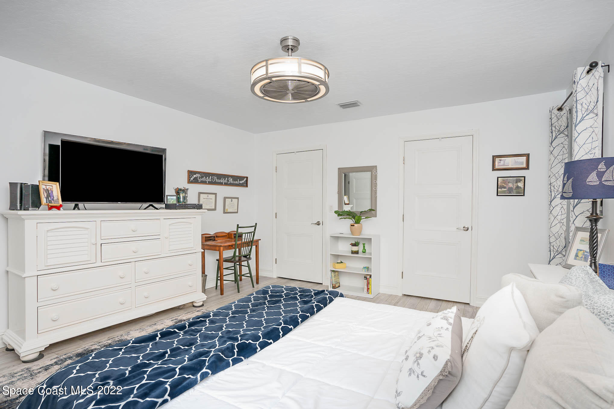 1425 Kitty Hawk Way Melbourne, FL 32940 - Photo 13 of 53 a bedroom with a bed and flat screen tv