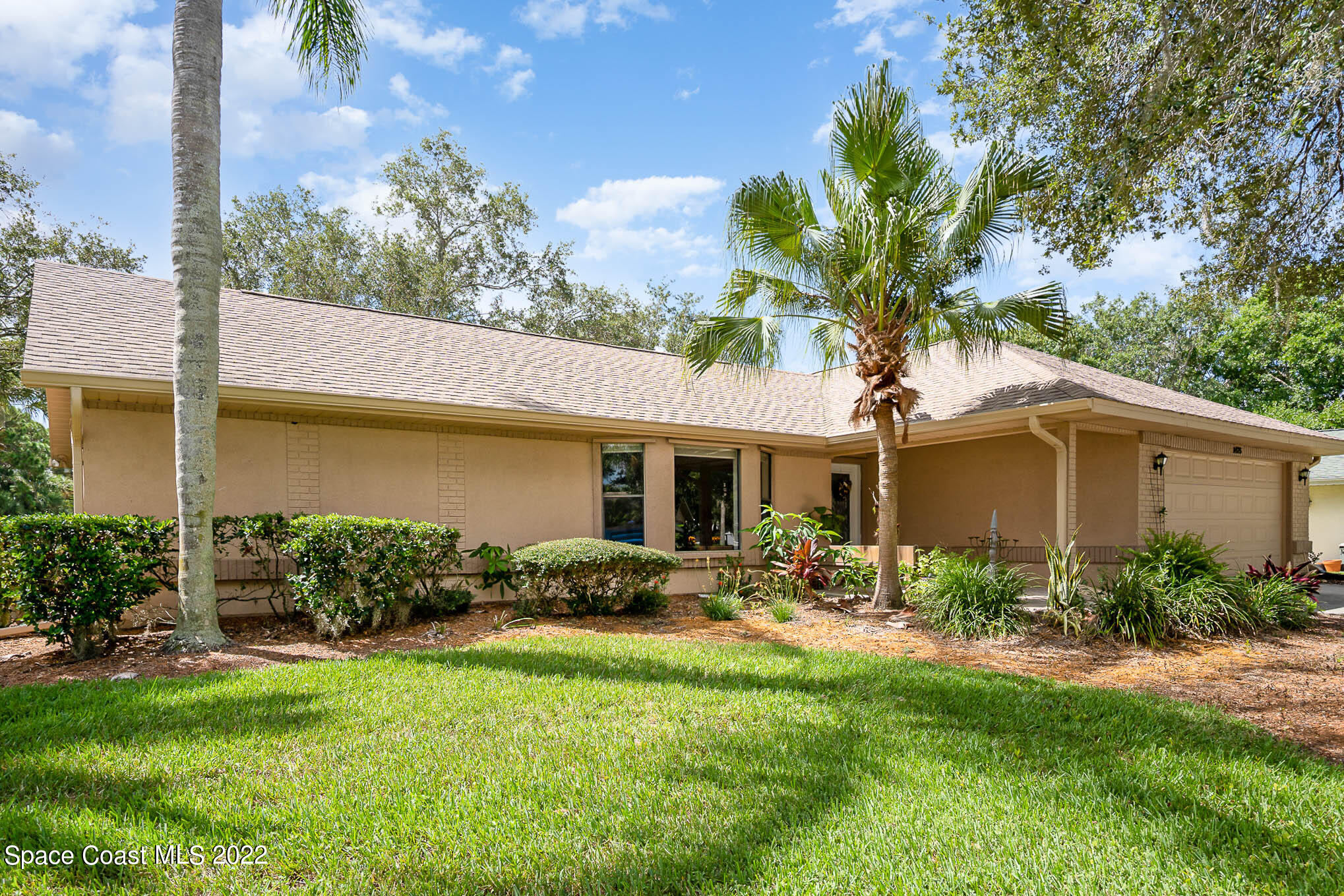 1425 Kitty Hawk Way Melbourne, FL 32940 - Photo 2 of 53 a front view of house with yard and green space