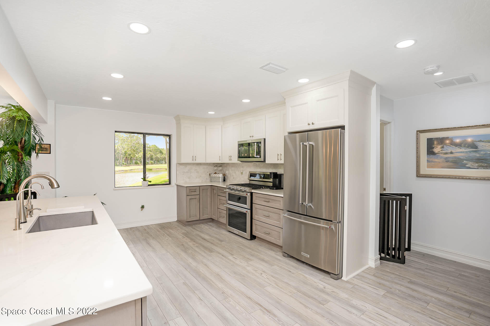1425 Kitty Hawk Way Melbourne, FL 32940 - Photo 22 of 53 a kitchen with stainless steel appliances a refrigerator sink and microwave