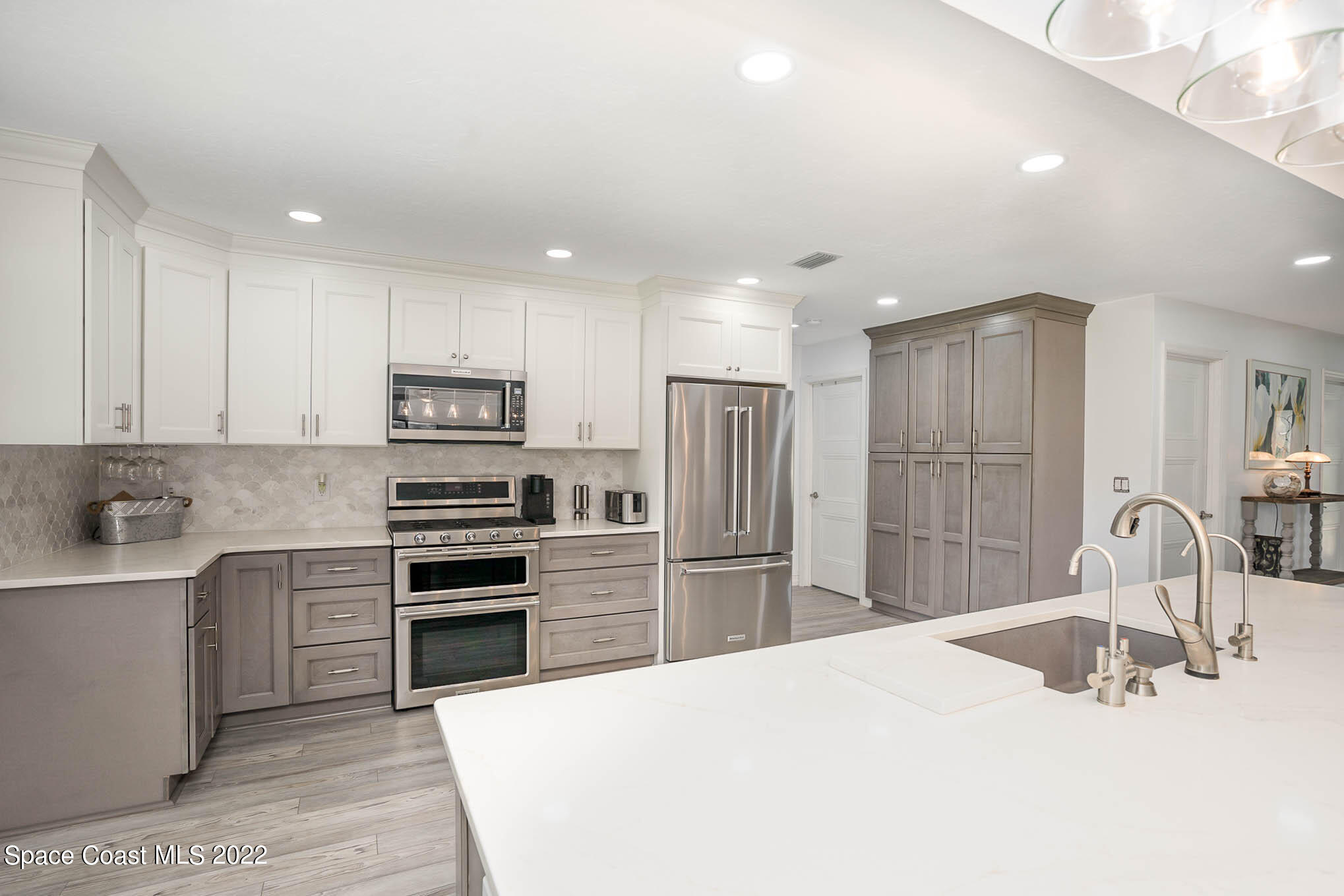 1425 Kitty Hawk Way Melbourne, FL 32940 - Photo 24 of 53 a kitchen with refrigerator cabinets and a sink