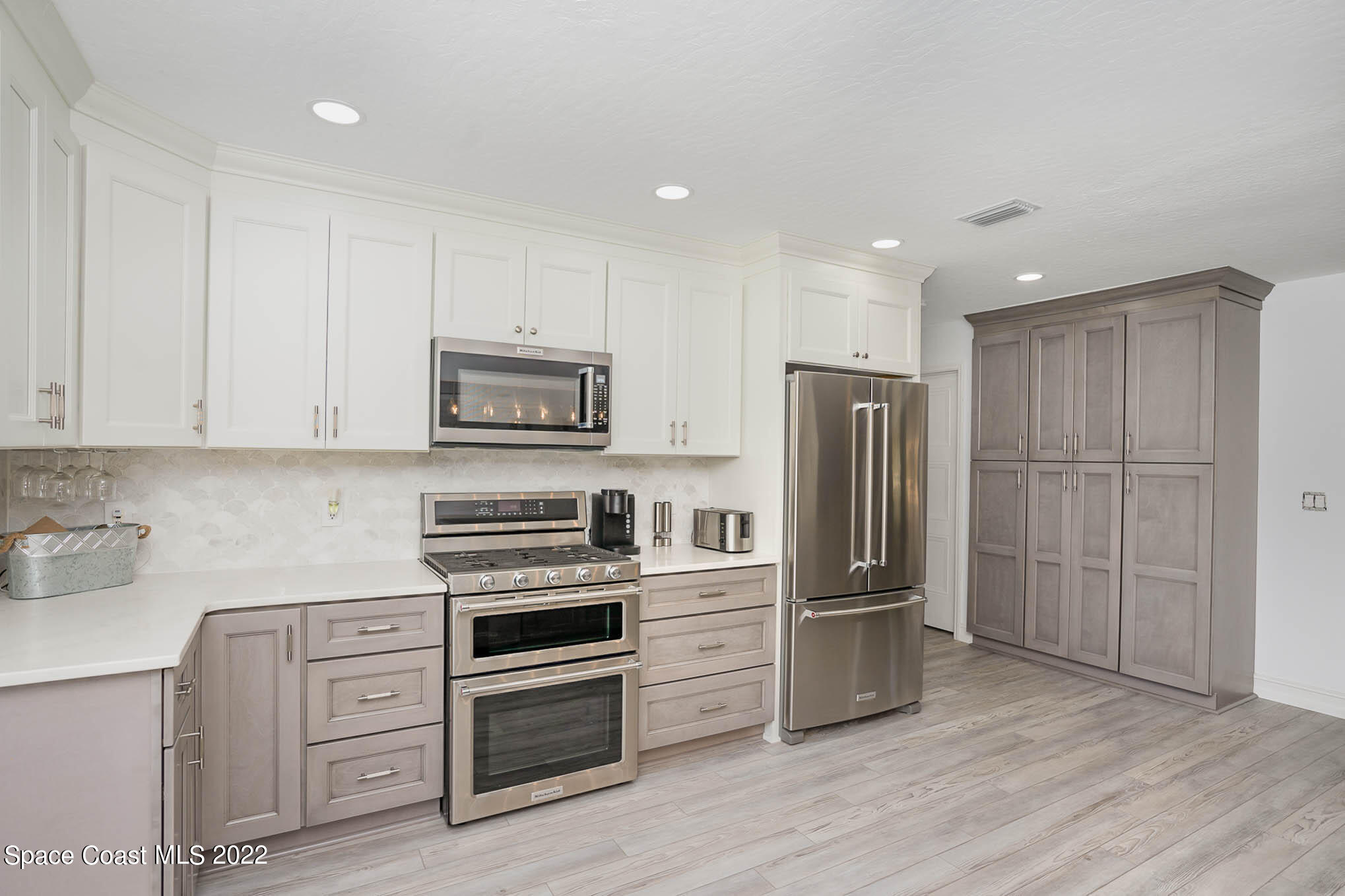 1425 Kitty Hawk Way Melbourne, FL 32940 - Photo 25 of 53 a kitchen with stainless steel appliances granite countertop a refrigerator and a stove top oven