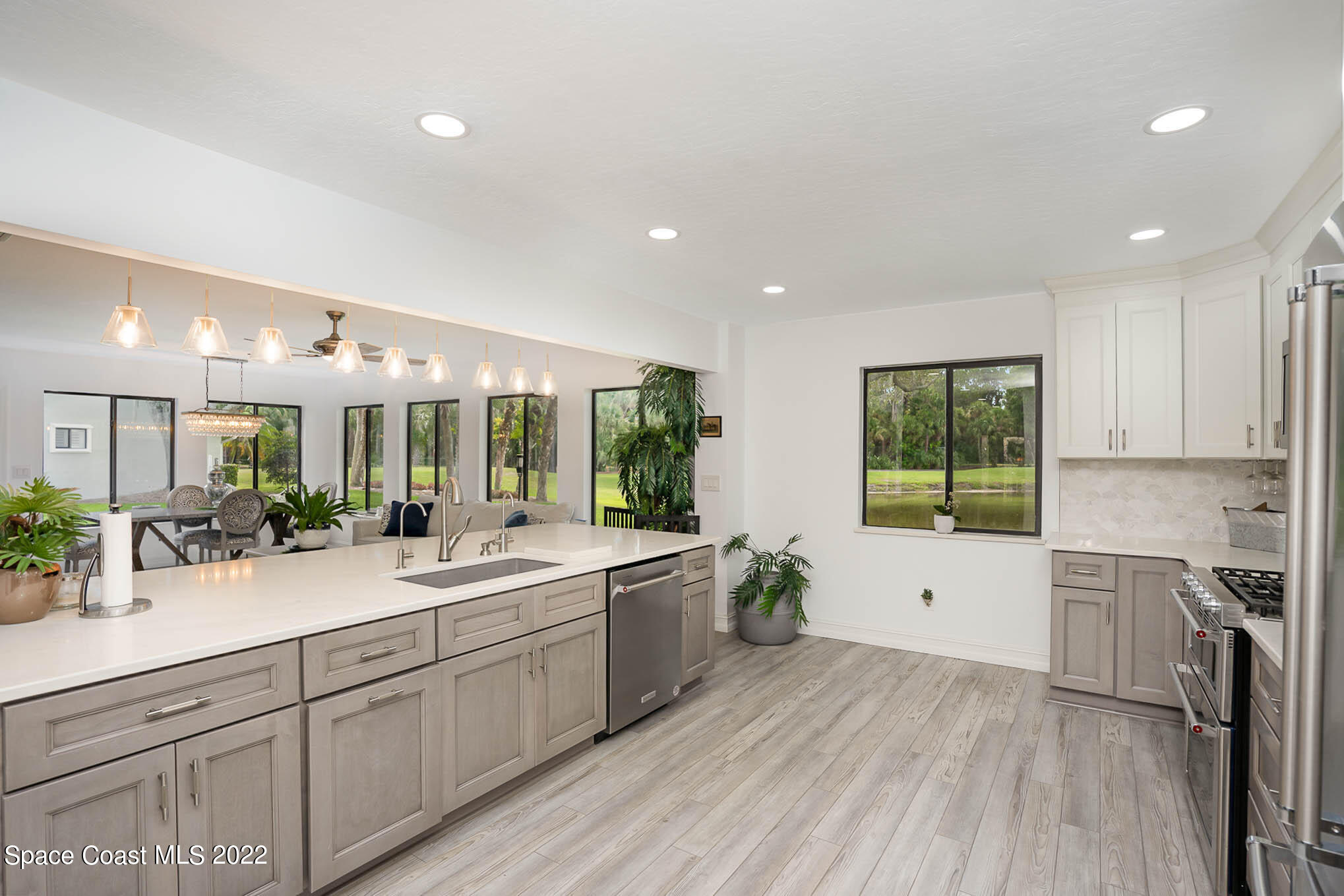 1425 Kitty Hawk Way Melbourne, FL 32940 - Photo 27 of 53 a large kitchen with kitchen island a sink stainless steel appliances and cabinets