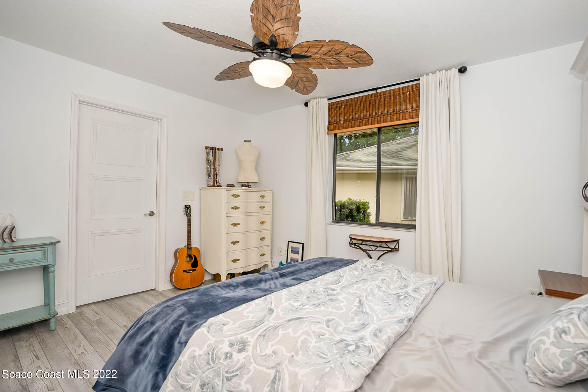 1425 Kitty Hawk Way Melbourne, FL 32940 - Photo 29 of 53 a bedroom with a bed and dresser with mirror