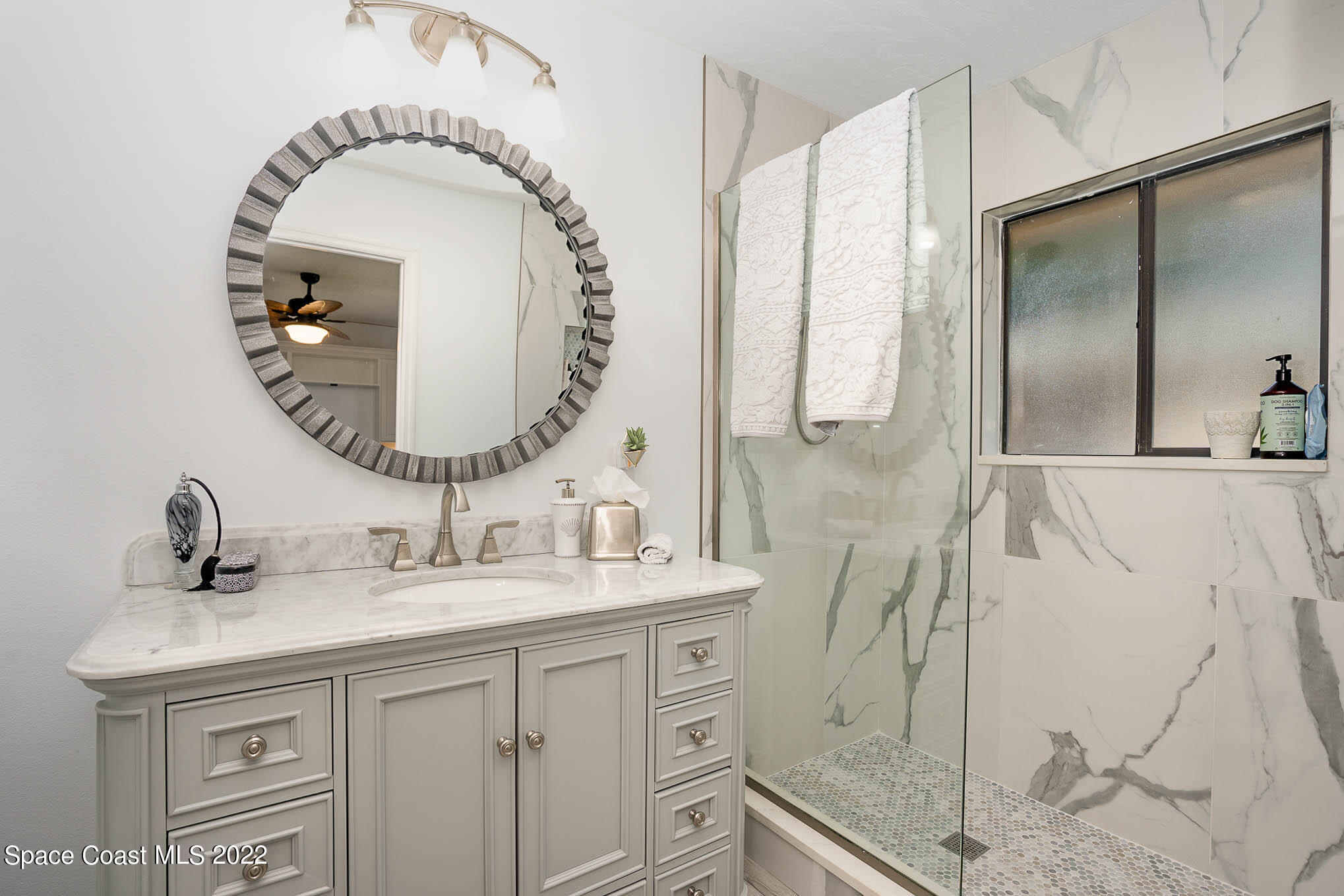 1425 Kitty Hawk Way Melbourne, FL 32940 - Photo 30 of 53 a bathroom with a sink and a mirror