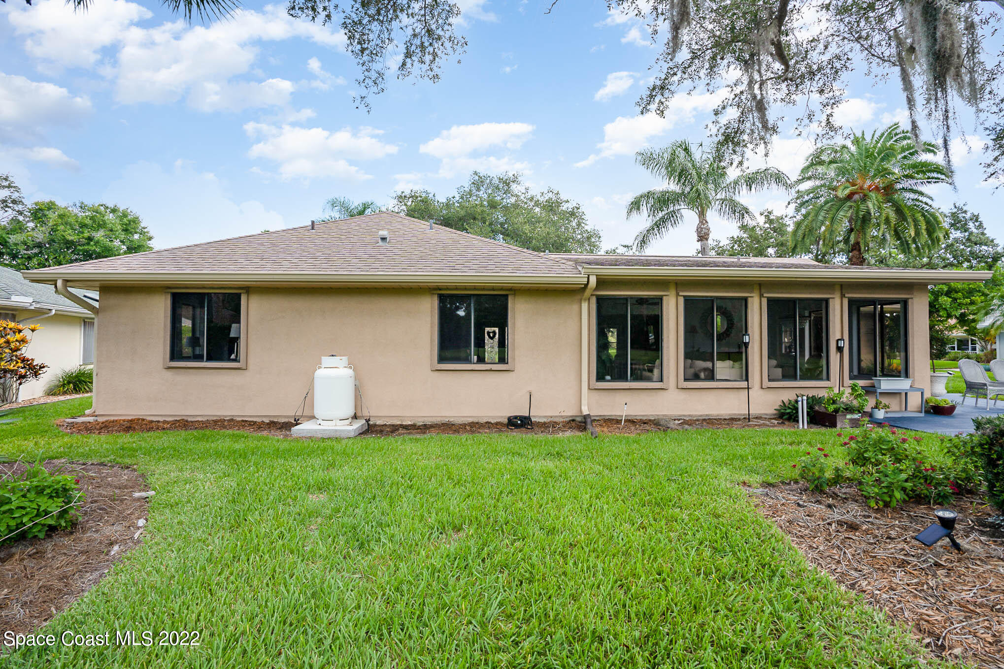 1425 Kitty Hawk Way Melbourne, FL 32940 - Photo 32 of 53 a front view of a house with a garden and porch