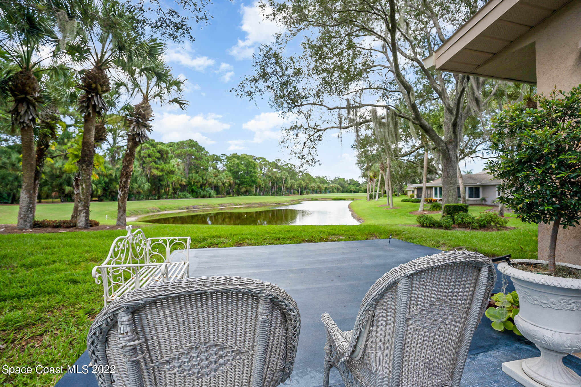 1425 Kitty Hawk Way Melbourne, FL 32940 - Photo 33 of 53 a view of a park with large trees and a fence