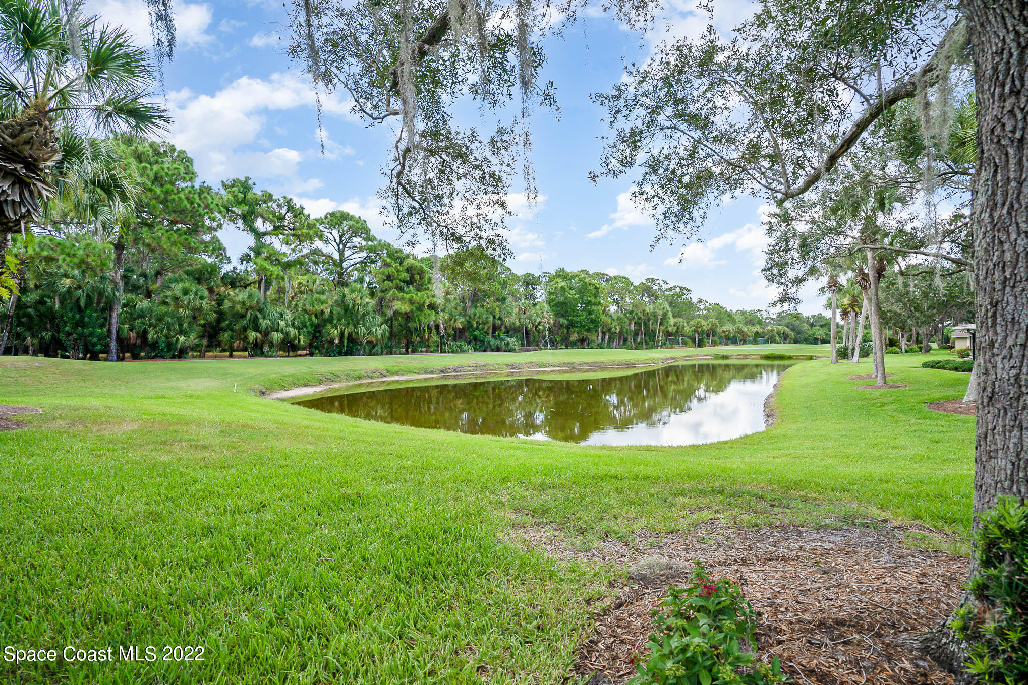 1425 Kitty Hawk Way Melbourne, FL 32940 - Photo 34 of 53 a view of a lake with a house in the background