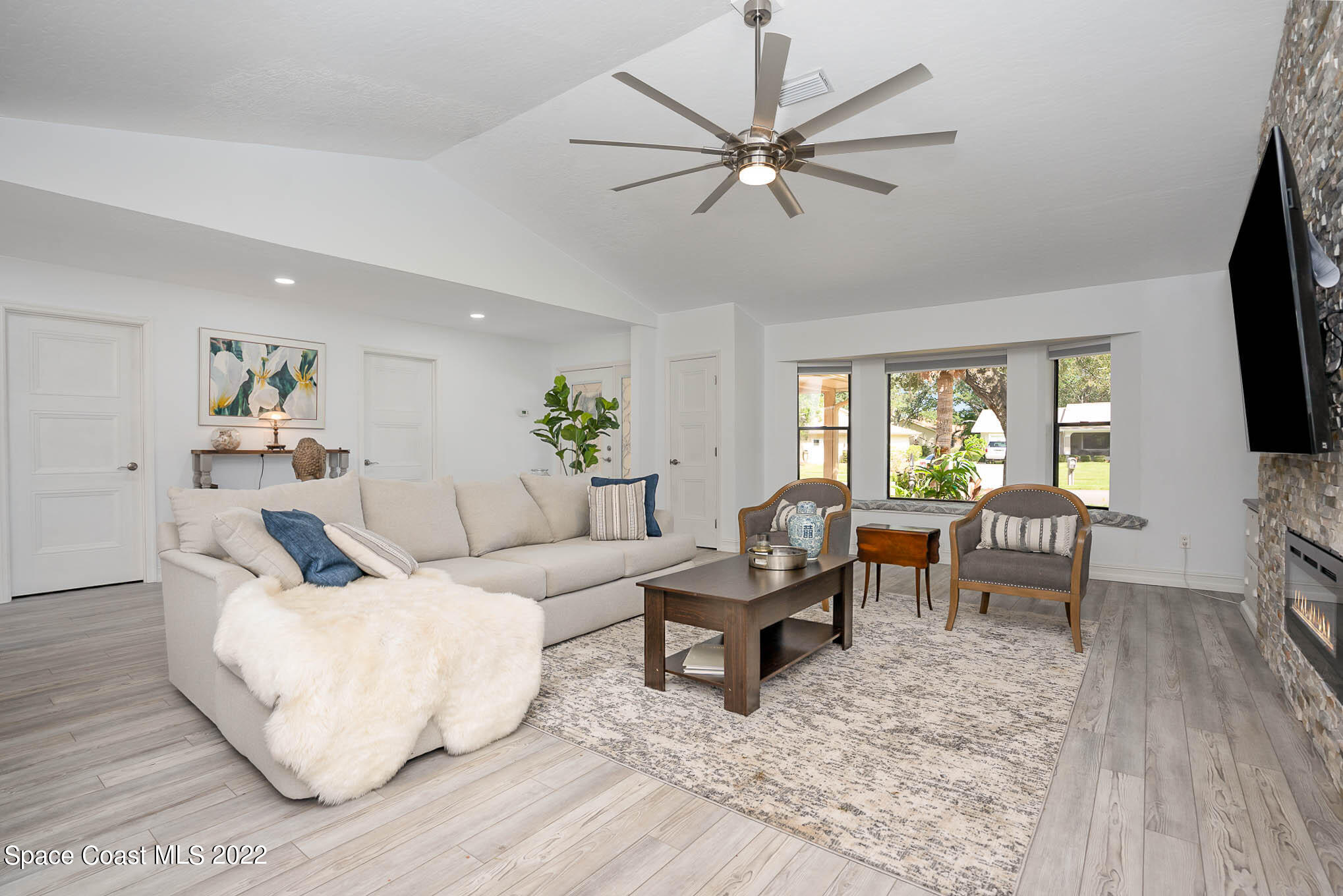 1425 Kitty Hawk Way Melbourne, FL 32940 - Photo 8 of 53 a living room with furniture and a flat screen tv