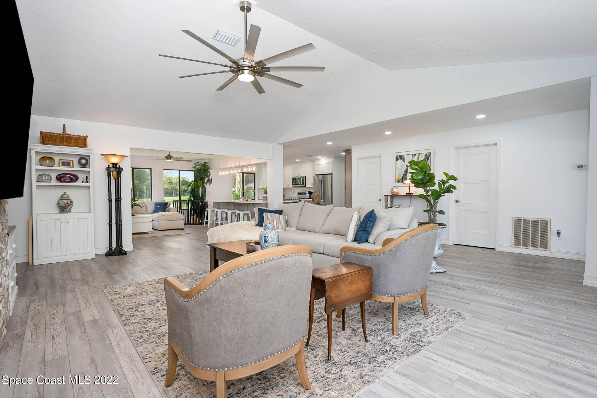 1425 Kitty Hawk Way Melbourne, FL 32940 - Photo 9 of 53 a living room with furniture a ceiling fan and a rug