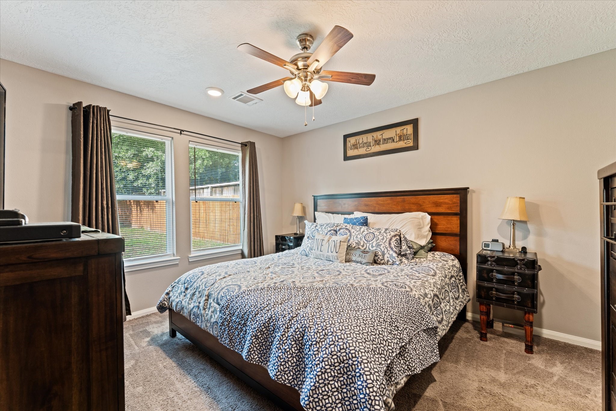 3998 Frontier Road Willis, TX 77378 - Photo 10 of 33 a bedroom with a large bed and a chandelier