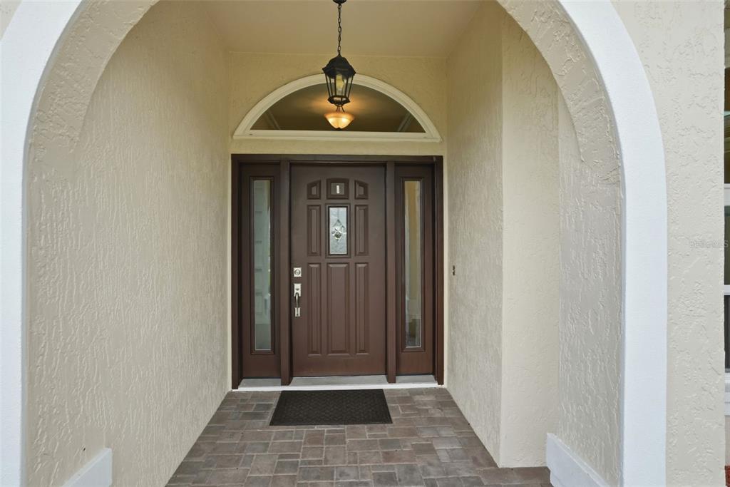 14228 Presteign Lane Spring Hill, FL 34609 - Photo 14 of 89 a view of a hallway with wooden floor and glass door