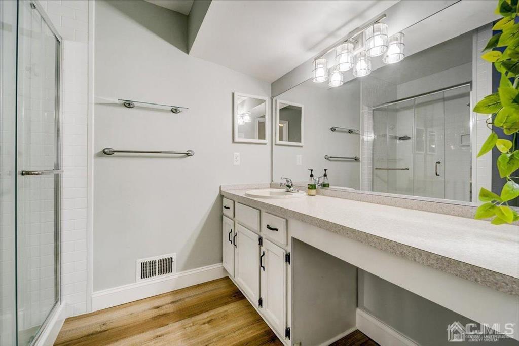 9 Tory Court Bedminster, NJ 07921 - Photo 19 of 26 a spacious bathroom with a double vanity sink and a mirror