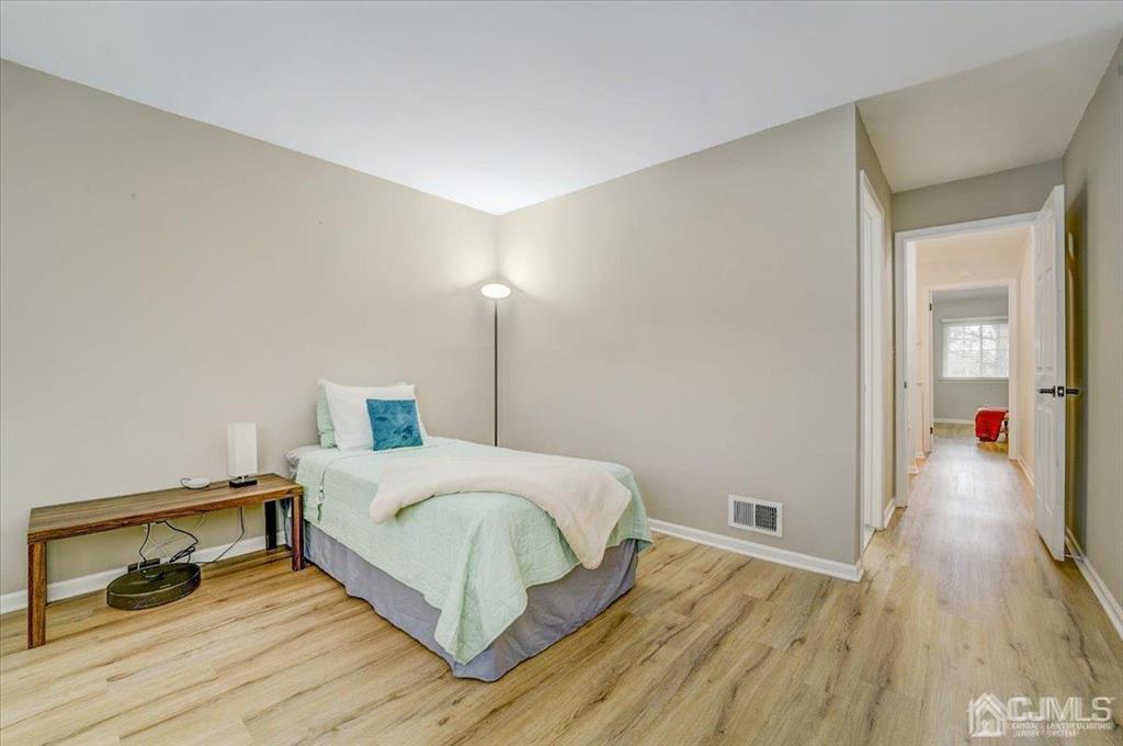 9 Tory Court Bedminster, NJ 07921 - Photo 23 of 26 a bedroom with a bed and wooden floor