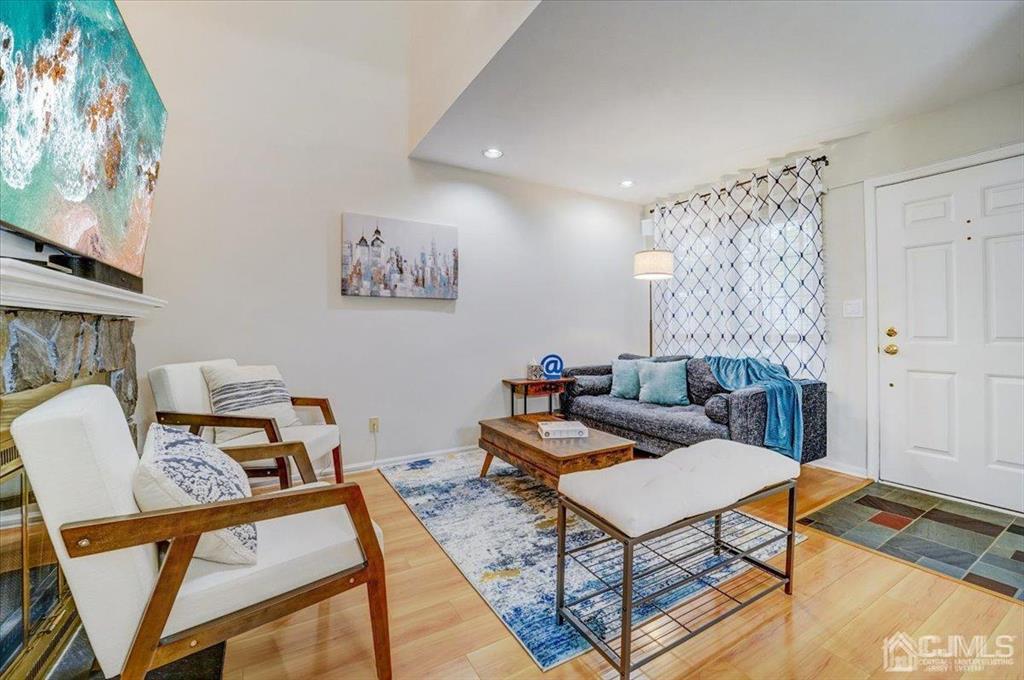 9 Tory Court Bedminster, NJ 07921 - Photo 10 of 26 a living room with furniture a rug and a painting on the wall