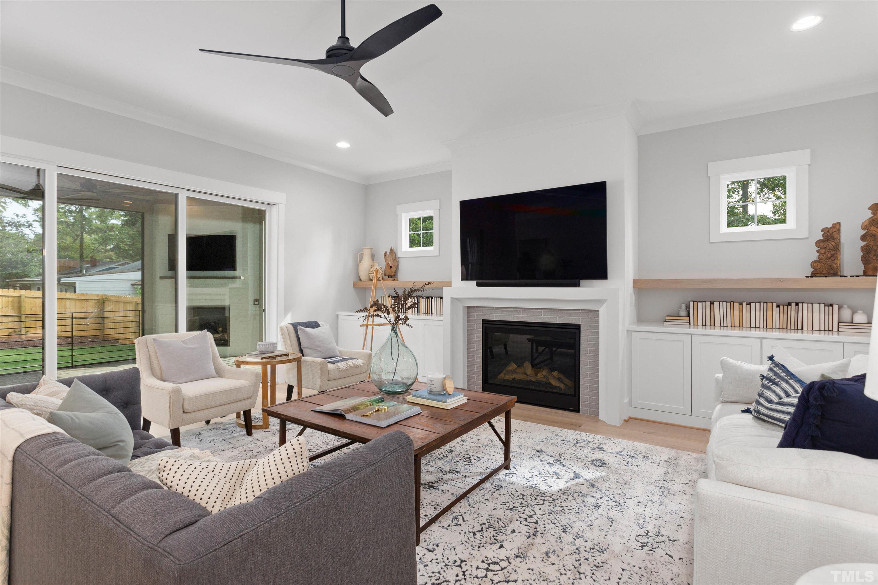 3508 Leonard Street Raleigh, NC 27607 - Photo 17 of 54 a living room with furniture a fireplace and a flat screen tv
