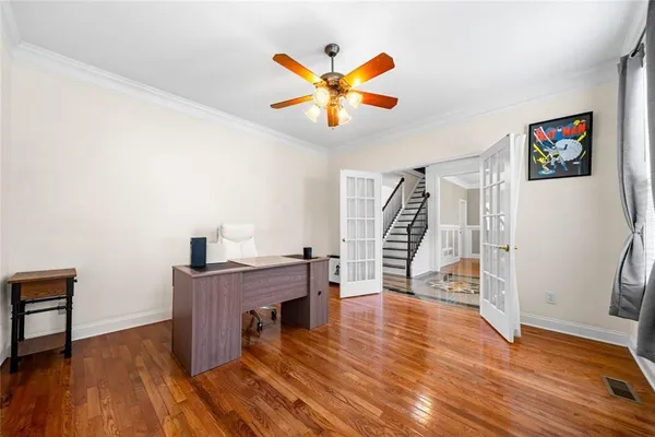 a view of a livingroom with a hardwood floor and a ceiling fan